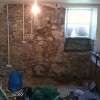 Damp Cottage wall after render stripped and repointed
