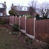 After Shot of new treated high quality sawn fence panels with concrete posts and gravel boards